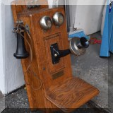 D21. Antique oak telephone by Julius Andrae & Sons Co. 